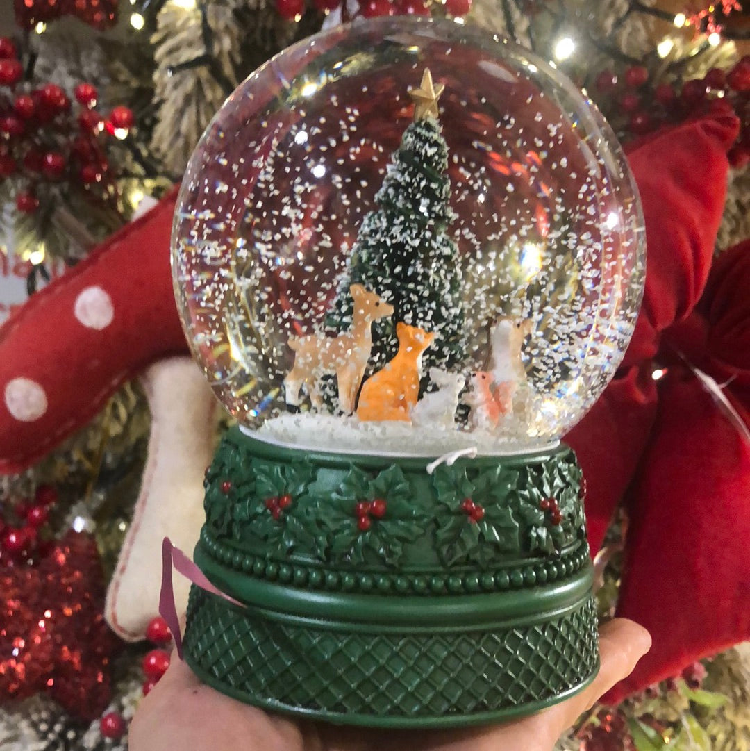 Snow globe with animals under the tree