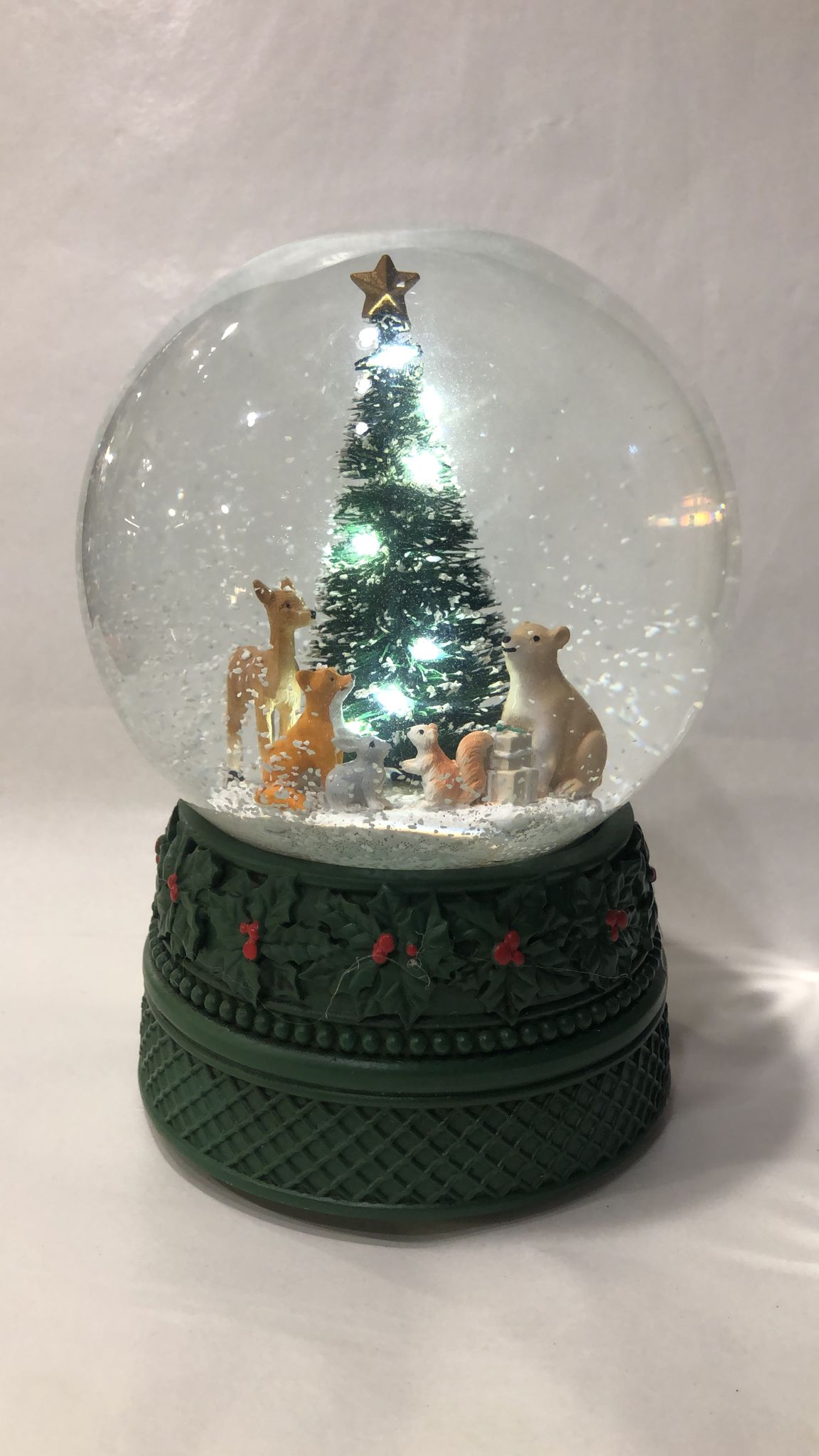 Snow globe with animals under the tree