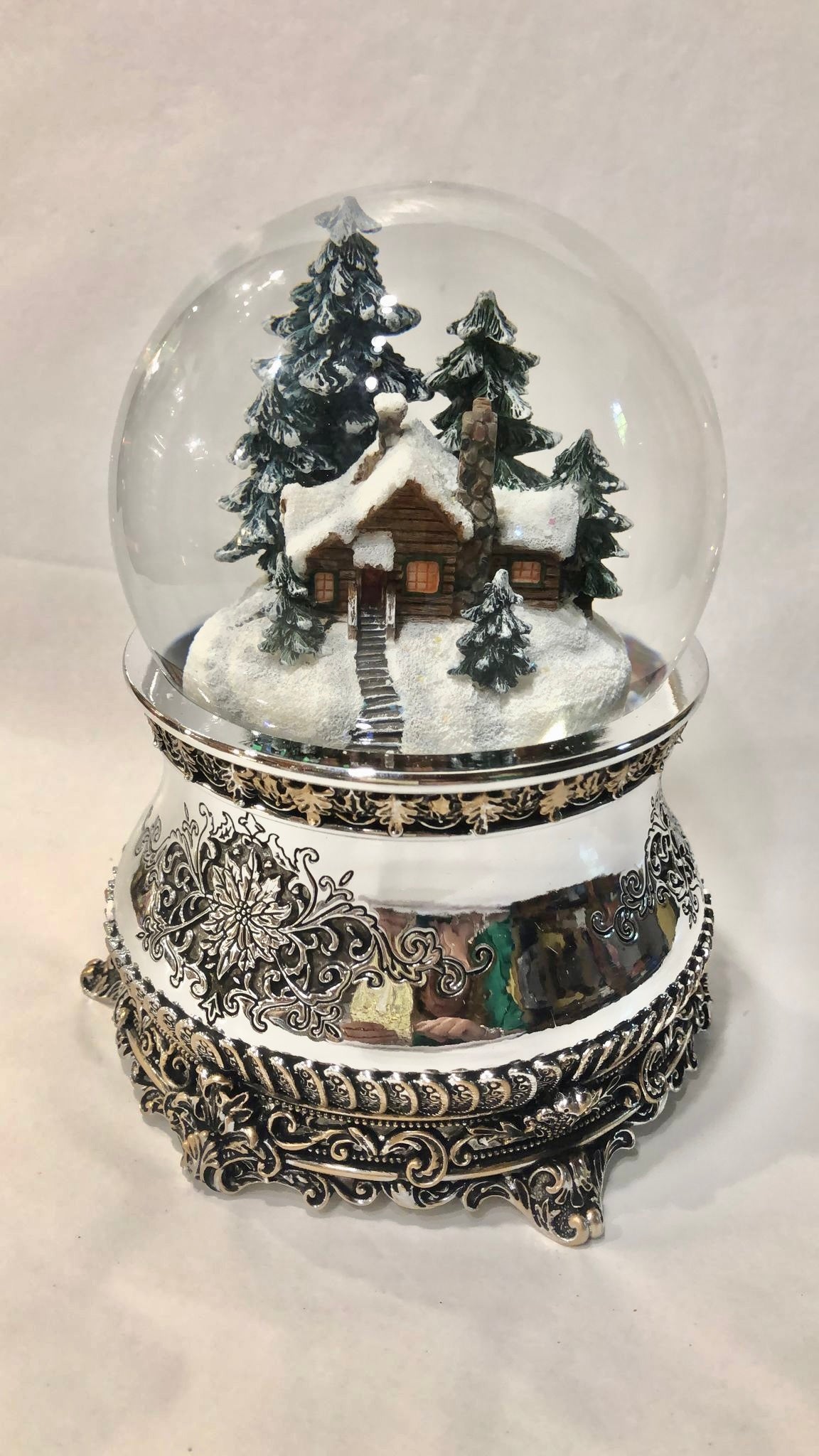 Snow globe with a house in the forest